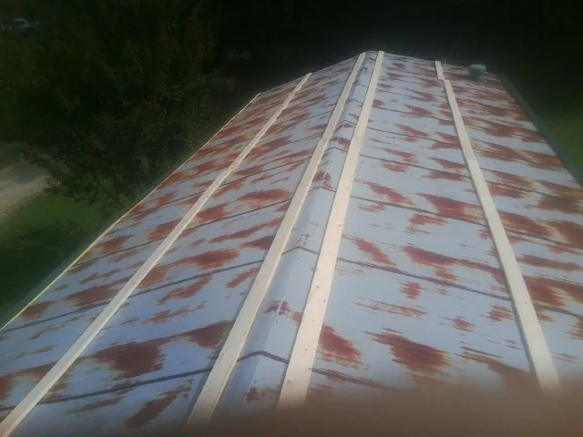 Rusted metal roof panels with new wood purlins before replacement — Storm Damage Roof Repair in Estacada by Roofing Brothers