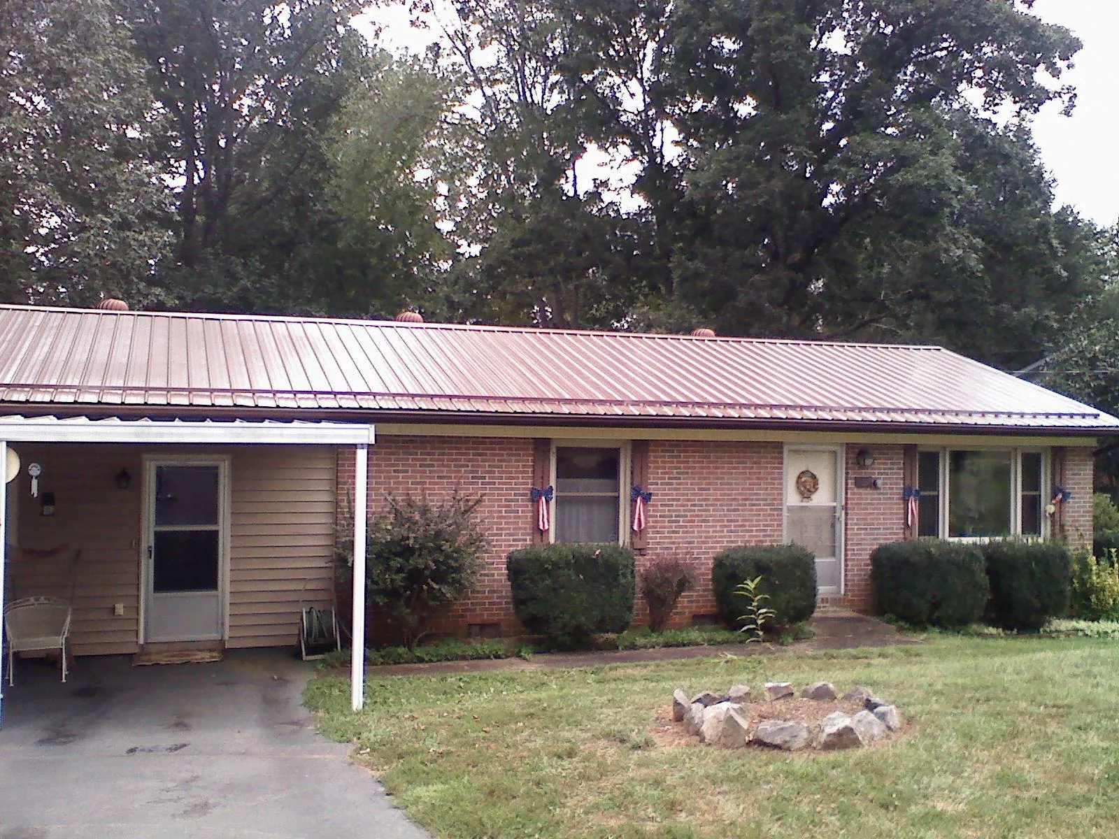 Bronze metal roof and carport on a brick ranch home — Roof Repair work by our crew in Estacada